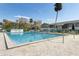 Large community pool with clear blue water, framed by palm trees and well-maintained buildings, ideal for relaxation at 840 Center Ave # 9, Daytona Beach, FL 32117