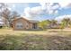 Backyard of the house showing grass, trees, and the exterior at 893 S Dean Cir, Deltona, FL 32738