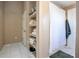 Neutral bathroom boasts a shower with white curtain, a linen closet, and white tile floors at 893 S Dean Cir, Deltona, FL 32738