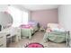 Bright bedroom featuring two beds, a large window, and a vanity desk at 893 S Dean Cir, Deltona, FL 32738