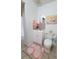 Updated bathroom featuring a white vanity, toilet, and painted brick wall at 906 E Wisconsin Ave, Deland, FL 32724