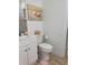 Cozy bathroom featuring a white vanity, toilet, and simple decor at 906 E Wisconsin Ave, Deland, FL 32724