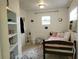 Cozy bedroom with tiled floors, natural light, and simple decor at 906 E Wisconsin Ave, Deland, FL 32724