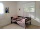 Well-lit bedroom with tiled floors, natural light and simple decor at 906 E Wisconsin Ave, Deland, FL 32724