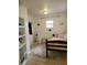 Modest bedroom with tiled floors, natural light, and simple decor at 906 E Wisconsin Ave, Deland, FL 32724