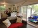 Open concept living room with sliding glass doors leading to a screened porch at 906 E Wisconsin Ave, Deland, FL 32724