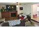 Spacious living room featuring a brick fireplace, plush sofas and decorative accents at 906 E Wisconsin Ave, Deland, FL 32724