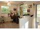Bright office space with a large window, vintage desk, and access to an enclosed lanai at 906 E Wisconsin Ave, Deland, FL 32724