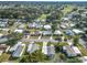 Overhead image displays the serene neighborhood, tidy landscaping, and close distance to a manicured golf course at 907 Rose Ln, The Villages, FL 32159