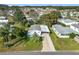 Home's exterior featuring a front yard, carport, and nearby trees at 907 Rose Ln, The Villages, FL 32159
