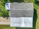 Overhead shot of a home with a driveway and backyard, surrounded by green grass at 907 Rose Ln, The Villages, FL 32159