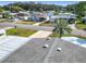 Aerial view of a home in a residential neighborhood with mature trees at 907 Rose Ln, The Villages, FL 32159