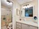 Bathroom featuring a glass door shower and a vanity with a white countertop at 907 Rose Ln, The Villages, FL 32159