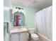 Bright bathroom with a single sink vanity, a shower/tub, and a green paint scheme at 907 Rose Ln, The Villages, FL 32159