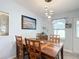 Warm dining room featuring wooden table set and stylish pendant lighting at 907 Rose Ln, The Villages, FL 32159