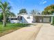 Charming single-story home with well-maintained lawn and a convenient carport at 907 Rose Ln, The Villages, FL 32159