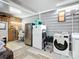 Garage with washer, dryer, utility sink, and ample storage space for tools and equipment at 907 Rose Ln, The Villages, FL 32159