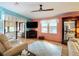 Bright living room with wood floors, light blue accent wall, and comfortable white sofa at 907 Rose Ln, The Villages, FL 32159