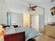 A spacious main bedroom features an ensuite bathroom and a light-colored wood floor at 907 Rose Ln, The Villages, FL 32159