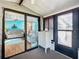 A sunroom with sliding glass doors has an open view of the living room at 907 Rose Ln, The Villages, FL 32159