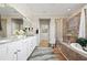 Elegant bathroom featuring a large vanity, walk-in shower, and soaking tub at 9580 Sw 71St Loop, Ocala, FL 34481