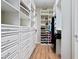 Custom walk-in closet featuring built-in shelves, drawers, and hanging rods to maximize storage space and organization at 9580 Sw 71St Loop, Ocala, FL 34481