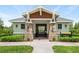 Charming community building entrance with stone accents, a well-kept lawn, and a sign for Heritage Gardens at 9580 Sw 71St Loop, Ocala, FL 34481