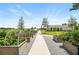 Scenic view of a well-maintained community garden with raised beds, lush greenery, and a charming building in the background at 9580 Sw 71St Loop, Ocala, FL 34481