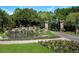 Stone Creek entrance featuring a scenic waterfall, lush landscaping, and welcoming signage at 9580 Sw 71St Loop, Ocala, FL 34481