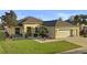 Charming single-story home featuring a well-manicured lawn, neutral paint, and an attached two-car garage at 9580 Sw 71St Loop, Ocala, FL 34481