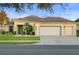 Charming single-story home featuring a well-manicured lawn, three-car garage, and a welcoming entryway at 9580 Sw 71St Loop, Ocala, FL 34481