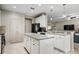 Bright kitchen with white cabinetry, center island, and a breakfast bar overlooking an adjacent living space at 9580 Sw 71St Loop, Ocala, FL 34481