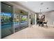 Kitchen and dining area with an open floor plan leading to a screened-in pool at 9580 Sw 71St Loop, Ocala, FL 34481