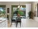 Open kitchen eating area with bar and seating area overlooking the pool area through a window at 9580 Sw 71St Loop, Ocala, FL 34481