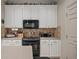 Well-equipped kitchen featuring an electric range, dark appliances and tile backsplash at 9580 Sw 71St Loop, Ocala, FL 34481