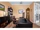 Comfortable home office with hardwood floors, classic grandfather clock, and ample workspace at 9580 Sw 71St Loop, Ocala, FL 34481