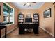 Inviting office featuring hardwood floors, a large window, and built-in bookshelves at 9580 Sw 71St Loop, Ocala, FL 34481