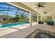 A large, covered patio with outdoor seating and views of the lush backyard and pool area at 9580 Sw 71St Loop, Ocala, FL 34481