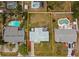 Aerial view of a home with a spacious, fenced backyard, neighboring homes with swimming pools, highlighted in yellow at 1074 Abeline Dr, Deltona, FL 32725