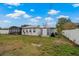 Large backyard with a screened patio, a storage shed, and lush grass at 1074 Abeline Dr, Deltona, FL 32725