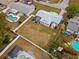 Aerial view of a backyard and screened in porch of home with neighboring homes with swimming pools at 1074 Abeline Dr, Deltona, FL 32725