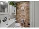 Bathroom with a stone accent wall, new toilet and fixtures, and a vanity at 1074 Abeline Dr, Deltona, FL 32725