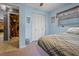 Cozy bedroom with blue walls, floating bed, and a closet with folding doors at 1074 Abeline Dr, Deltona, FL 32725