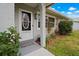 Inviting front entrance with decorative glass door, manicured bushes, and a welcome mat at 1074 Abeline Dr, Deltona, FL 32725