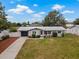Charming single-story home featuring a well-manicured lawn, attached garage, and inviting front entrance at 1074 Abeline Dr, Deltona, FL 32725
