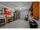 Spacious garage featuring lots of shelves, storage, and garage door at 1074 Abeline Dr, Deltona, FL 32725