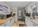 Efficient kitchen featuring stainless steel appliances, granite counters, white cabinetry, and tile flooring at 1074 Abeline Dr, Deltona, FL 32725