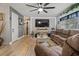 Cozy living room featuring stylish textured walls, a large ceiling fan, and wood flooring at 1074 Abeline Dr, Deltona, FL 32725