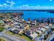 Aerial view of community buildings with tile roofs next to a stunning lake under a blue sky with scattered clouds at 1102 Bocana Dr # 1102, Casselberry, FL 32707