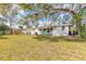 Expansive backyard featuring lush greenery and a playset at 1117 Berkshire Rd, Daytona Beach, FL 32117